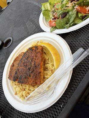 Grilled and Blackened Salmon on rice with a side salad.