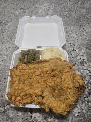 Thursday special chicken fried steak is huge with mash potatoes and green beans.