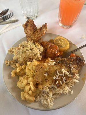 Buffet style food (fish, rice, Mac & cheese, dressing, yams, fried chicken.