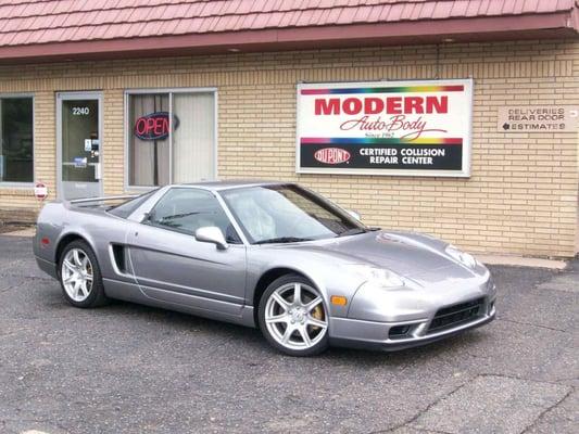 Front of Modern Auto Body with restored car