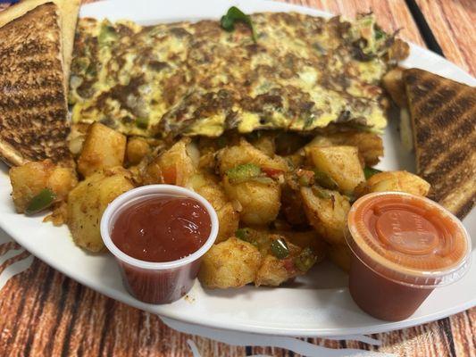 Steak omelette. Hot sauce optional.
