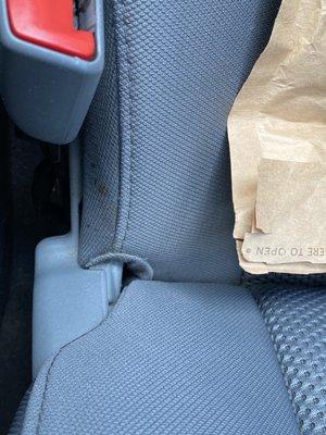 Seat dirt that was overlooked? It came off with a dry tissue I had on me.