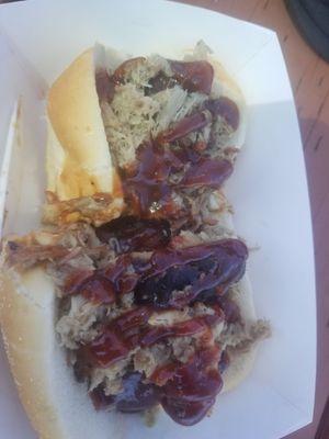 Bacon wrapped hotdogs topped with pulled pork and bbq sauce.