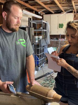 Jacob explaining to office staff what to look for in recycling of automotive converters