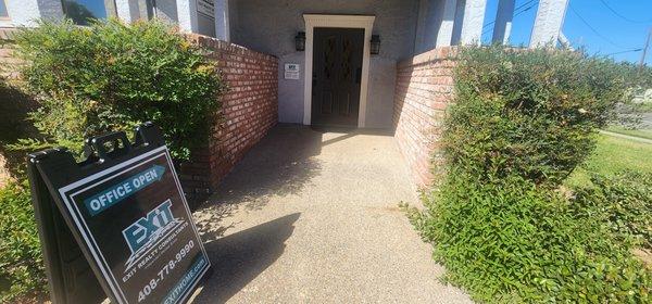 Front entrance into the office with the open office sign.