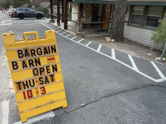 Exterior of church with the hours of operation for the Bargain Barn