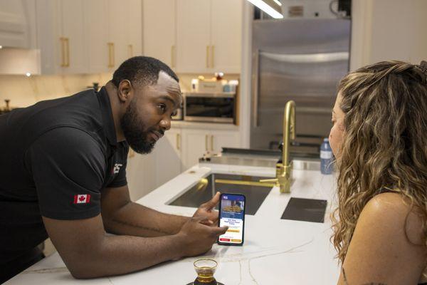 ARS Repair Inc. Technician speaking with customer in the customers' kitchen