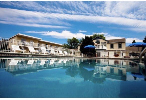 Salt water pool. Patio with umbrellas. Motel.