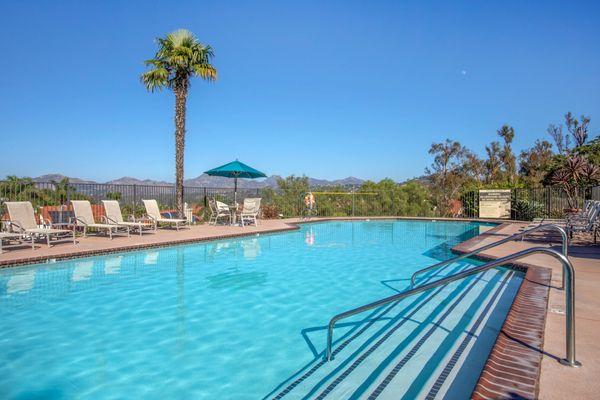 Swimming pool surrounded by lounge chairs.