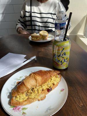 Note: Small 6" plate with small croissant and a small sourdough bread sandwich .