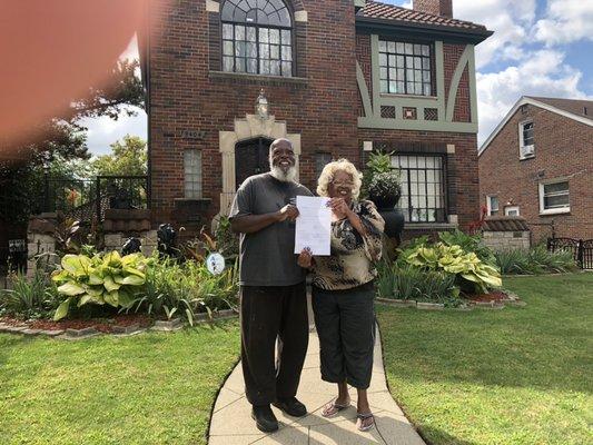 Delivering a deed to a National Faith Homebuyers Family.