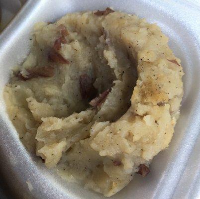 Grey looking mashed potatoes with tons of black pepper.