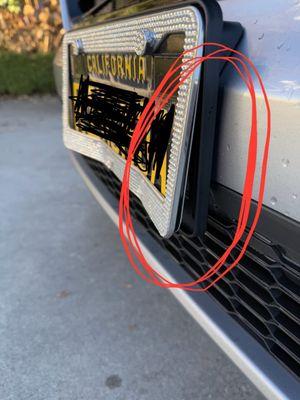 Side view of license plate. You can see that it's bent forward.