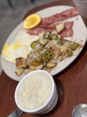 Fried eggs, turkey bacon, potatoes with jalapeños and onions with a side of grits