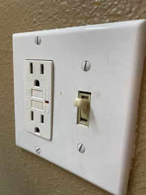 Gunk on the light switch plate. These get touched a lot and have to be cleaned daily.