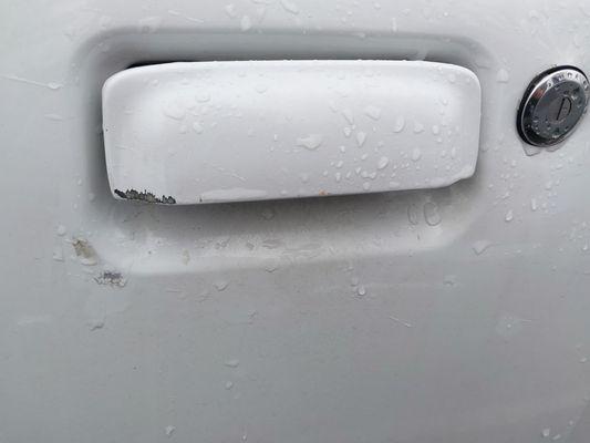Door handle and panel sustained minor but very noticeable (white paint has its downsides I guess...) damage while being serviced here