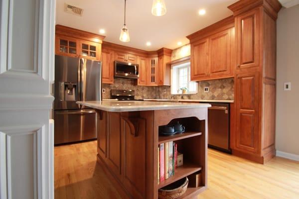 We designed and remodeled a small and cramped kitchen by opening up the walls and adding additional prep space and seating by...