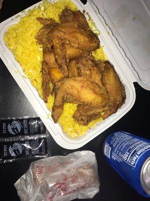Egg fried rice with chicken wings and egg roll with a Pepsi can