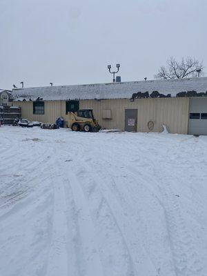 they used that yellow machine to shove the cars in the snow, messing the car more up not caring about people's car