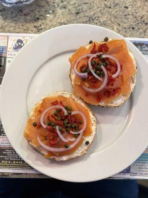 smoked salmon everything bagel layered with cream cheese, red onions, capers, and sun-dried tomatoes