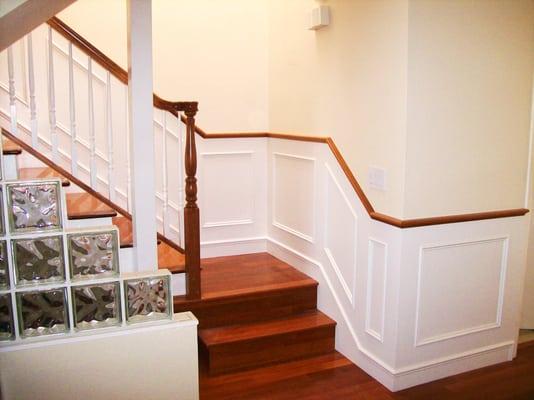 Cherry wood combination stair with colonial style wainscott painted with matching balusters