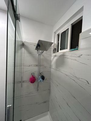 Installed shower walls and shower door and shower head
