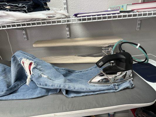 Touch up and ironing finished hemmed jeans.