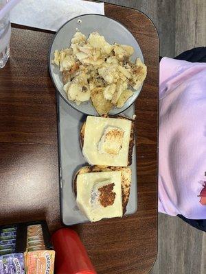 Eggs in a nest and side of home potatoes