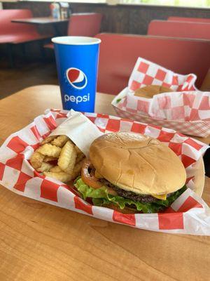 Avocado burger, fries and a drink