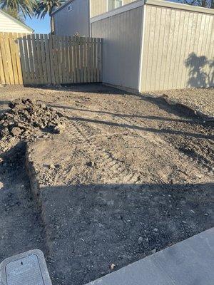Removed lose dirt, large mound of compacted dirt, tree stump, and graded the front. (We asked him to leave that small pile for infill)