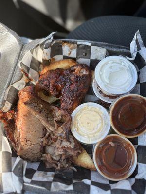 To meat platter, tender brisket, flavored chicken, wing, macaroni, and cheese, and baked beans. Also barbecue sauce and ranch dressing.