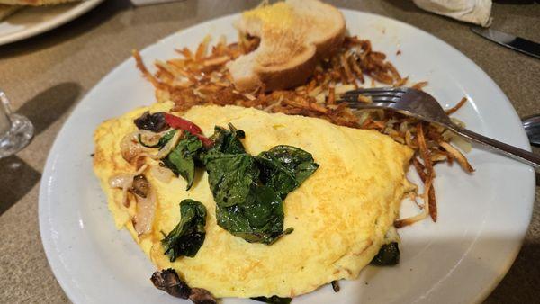 Veggie omelet with very little bit of hasbrowns and presentation is not there at all