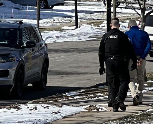 Criminal Photographer of Images by Gerace - in handcuffs being arrested and taken into Police custody,