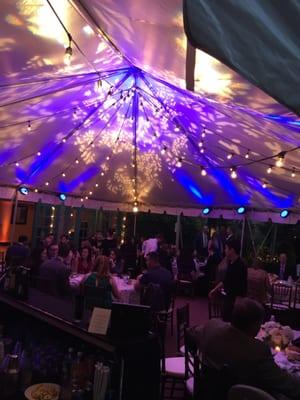 Private wedding lighting, outdoors in a tent.