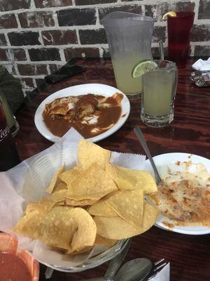 Pitcher of House Margaritas on the Rocks, Beef Tamale, cheese enchilada, chicken burrito, and chori cheese dip with chips and salsa.