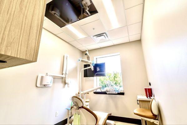 Our rooms provide noise canceling headphones, TV's on the ceiling, comfy chairs and large monitors to show your detailed treatment plans.