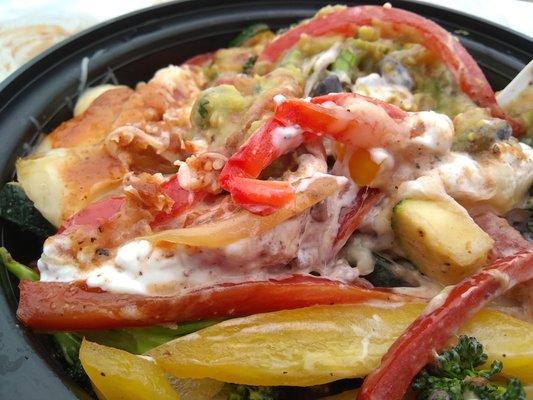 (Closeup, stirred around a bit) Burrito Bowl with veggies, black beans, and hot red salsa.