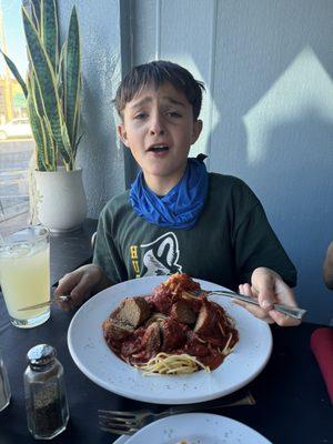 My son, enjoying spaghetti and meatballs