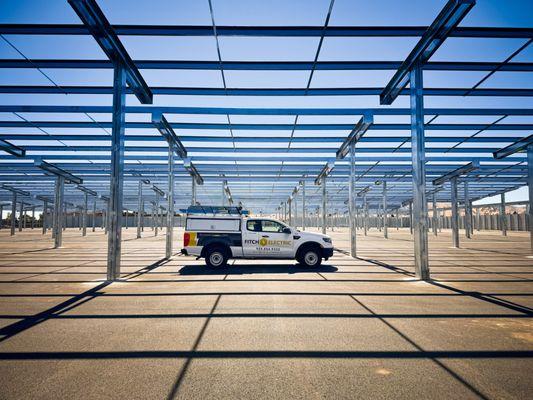 Provide under-canopy lighting and AC supply-side power for solar farms, coordinating underground distribution panels and switchgear.