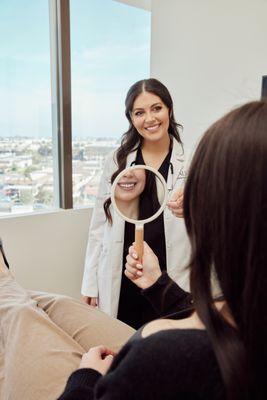 Dr. Saad helping a patient map out her veneer goals--every detail designed for a custom, confident smile.
