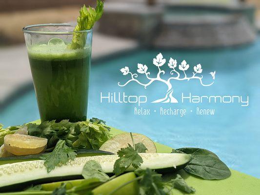 Hilltop Harmony Logo. Relax. Recharge. Renew. Fresh green juice next to sliced cucumber, celery, spinach and lemon by the pool.