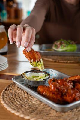 Crispy Boathouse wings tossed in Fresno hot sauce - our signature wings at The Boathouse in Greenport on the North Fork