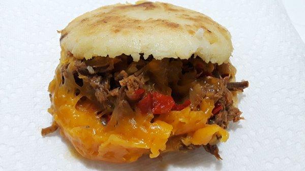 Arepa Pelúa: Grilled corn cake stuffed with seasoned shredded beef & yellow cheese