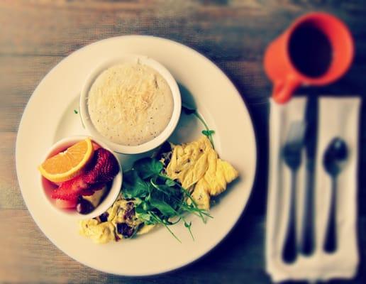 scrambled eggs, fresh fruit, grits and coffee