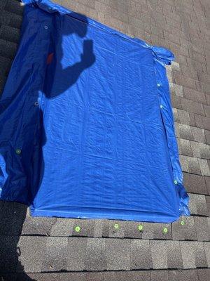 The tarp placed on my roof by MR. It was not placed over the peak of the roof & it was not secured properly causing more damage!
