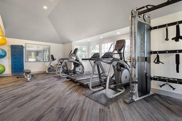 Fitness center with cardio and strength training equipment.