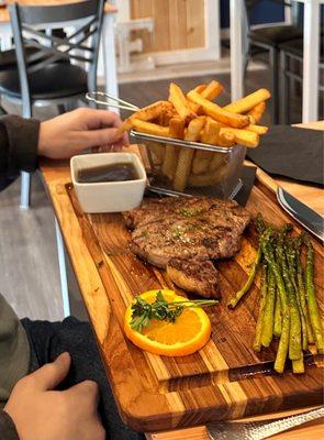 Ribeye Steak with asparagus and fries.