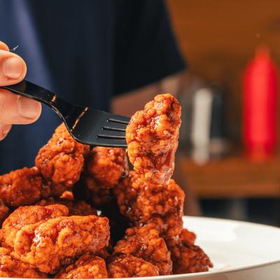 A saucy boneless wing ready to eat