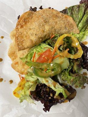 Samosa, with a side of Saint Louis sauce and salad.