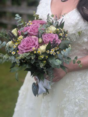 Bridal bouquet with lavender, eucalyptus, daisies, and white and mauve roses.